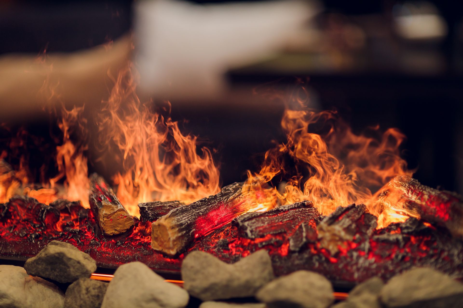 a close up of a fireplace filled with logs and flames .