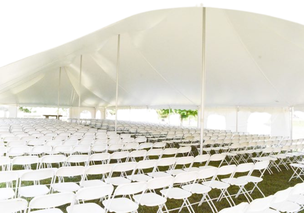 Rows of white folding chairs under a white tent