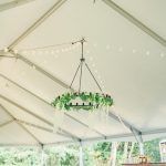 A chandelier is hanging from the ceiling of a tent.