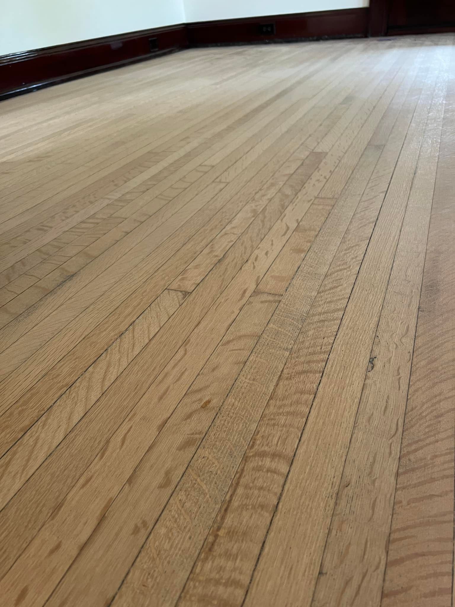 A close up of a wooden floor in a room.
