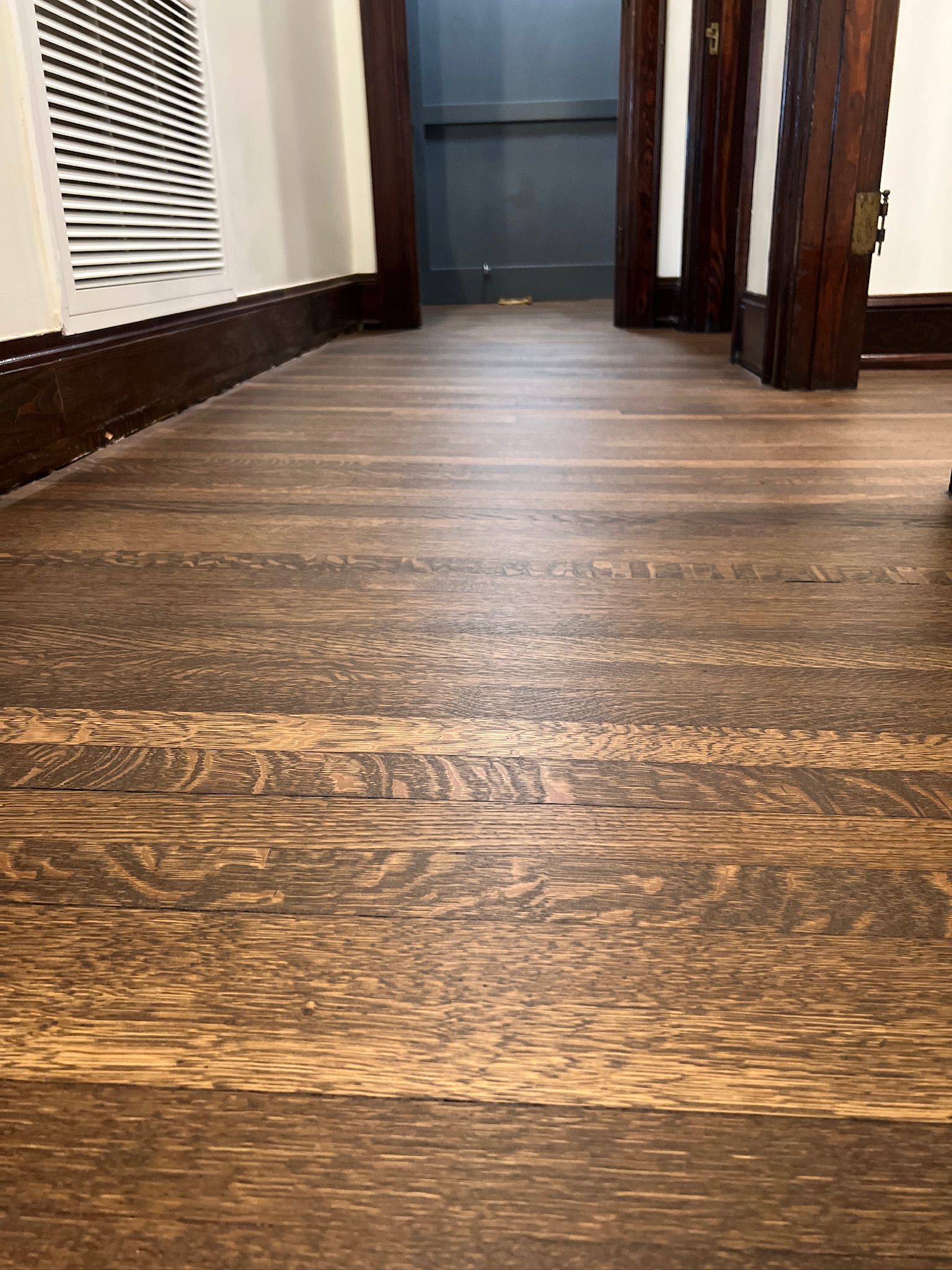 A close up of a wooden floor in a room.