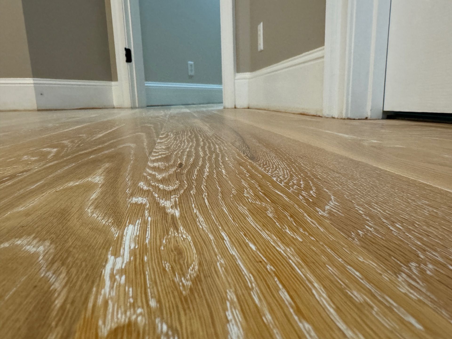 A close up of a wooden floor in a hallway