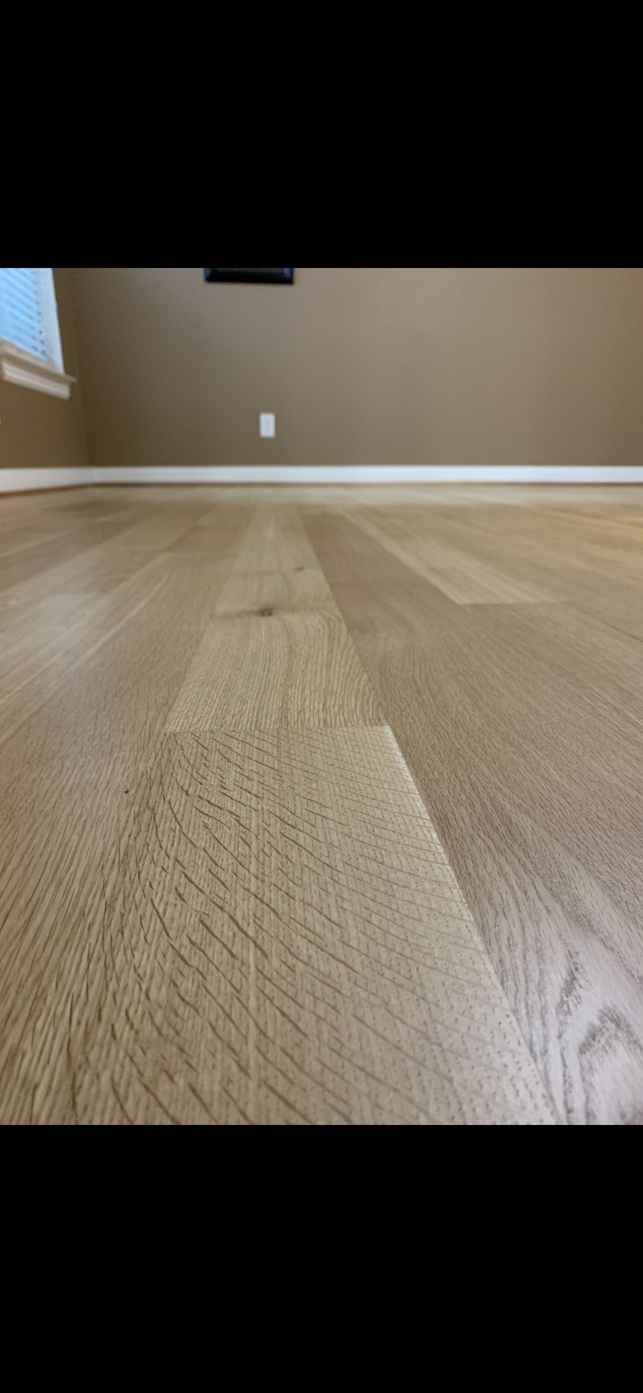 A close up of a wooden floor in a living room.