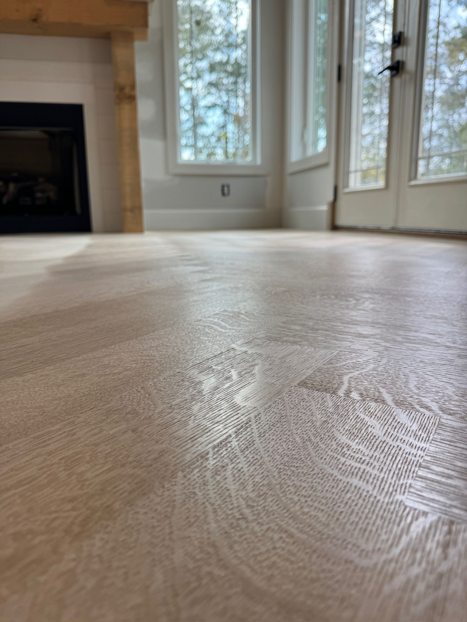 A living room with hardwood floors and a fireplace.