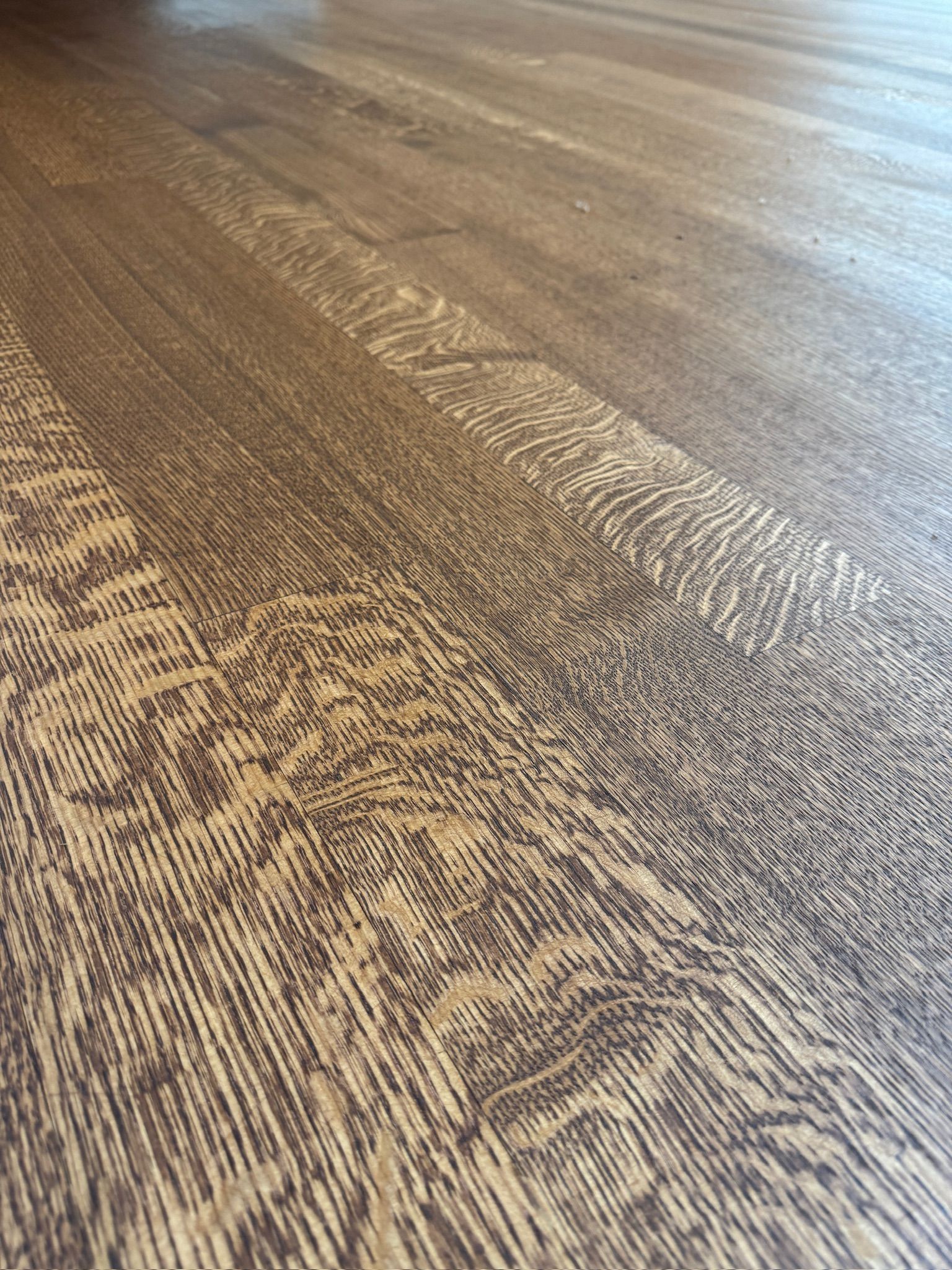 A close up of a wooden floor with a pattern on it.