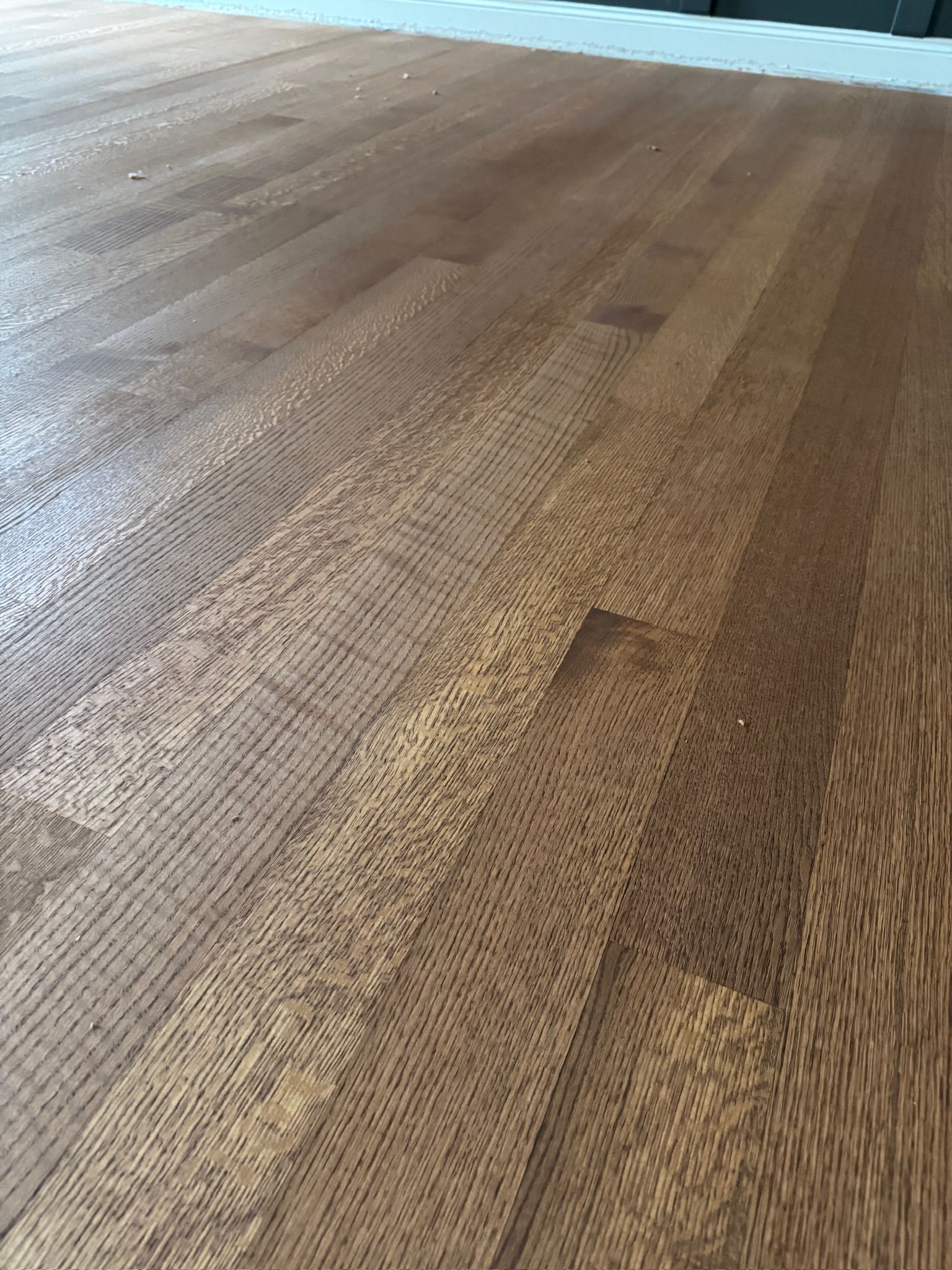 A close up of a wooden floor in a room.