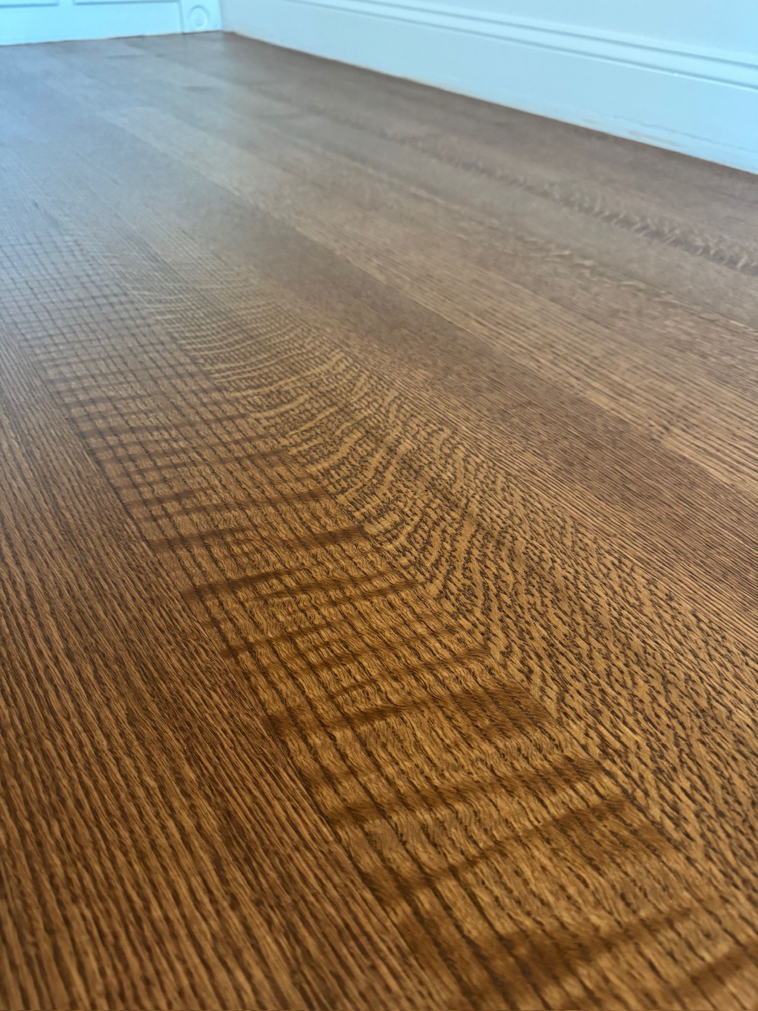 A close up of a wooden floor in a room.