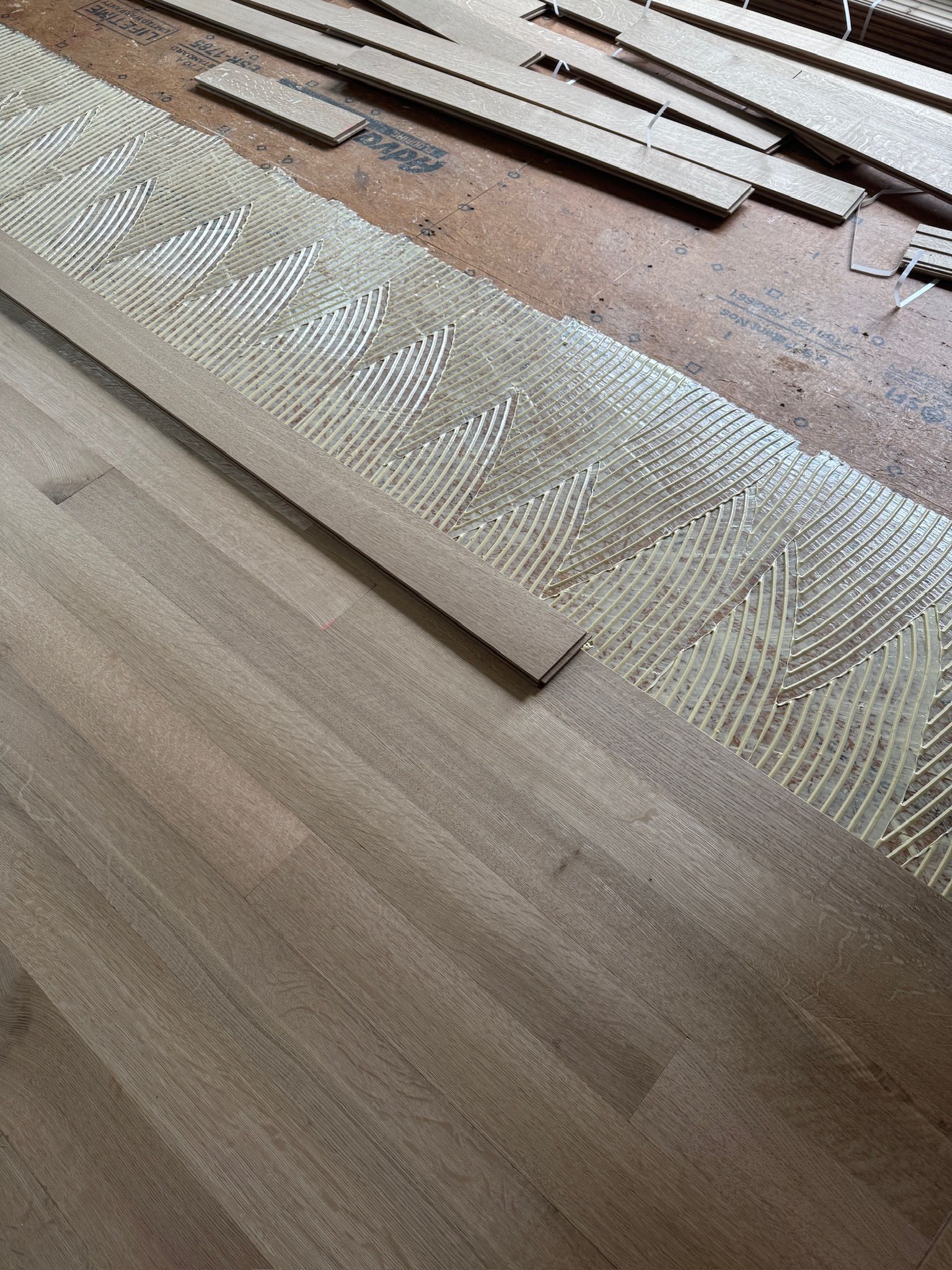 A piece of wood is sitting on top of a wooden floor.