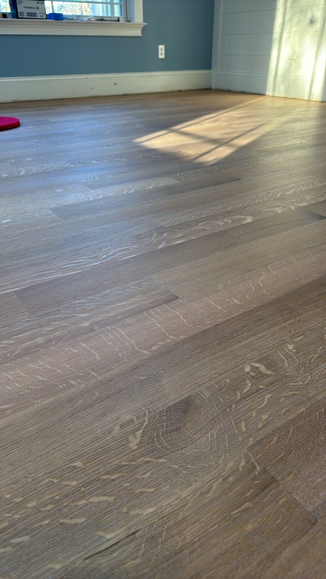 A close up of a wooden floor in a living room.