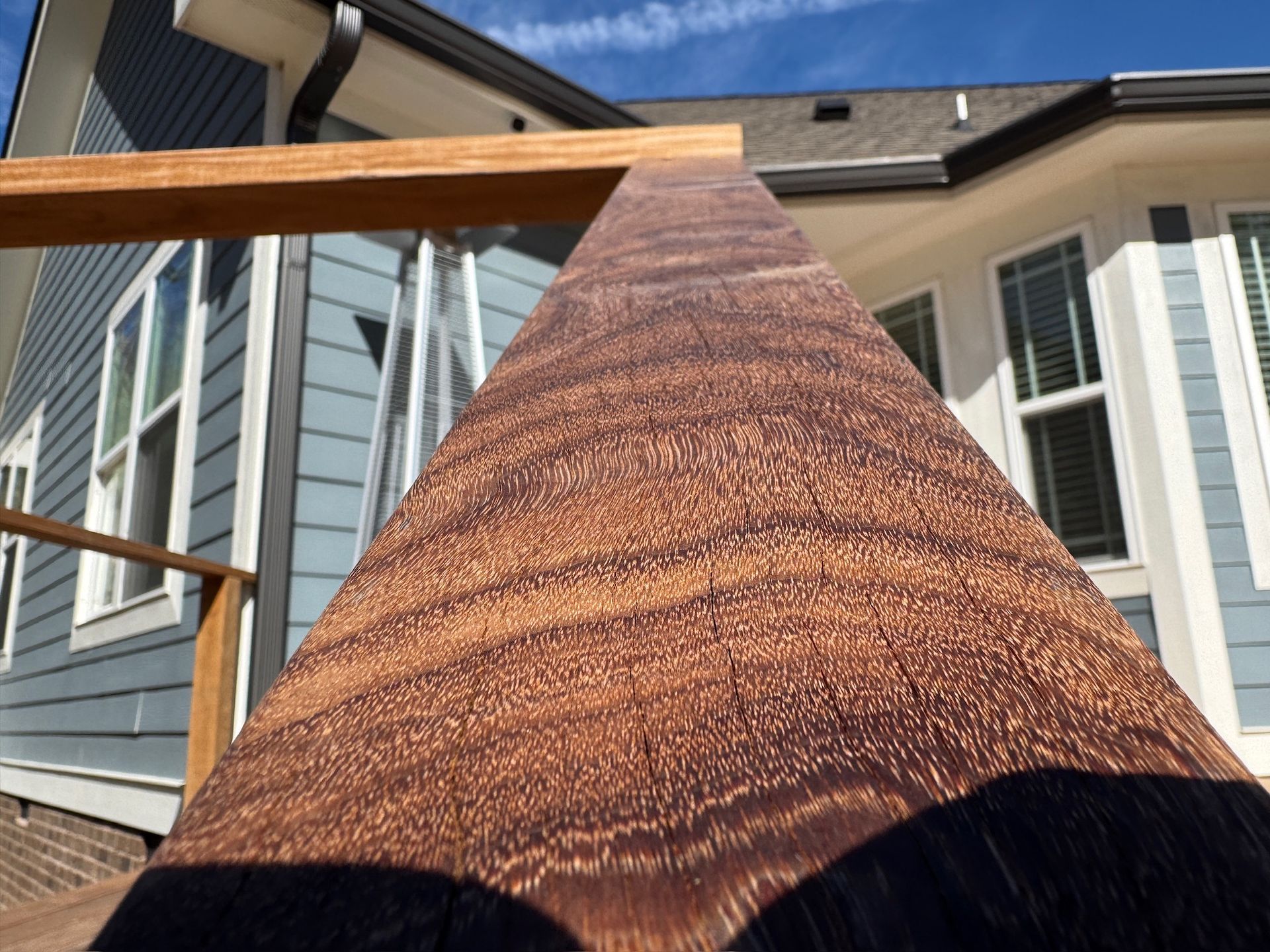 A close up of a piece of wood in front of a house