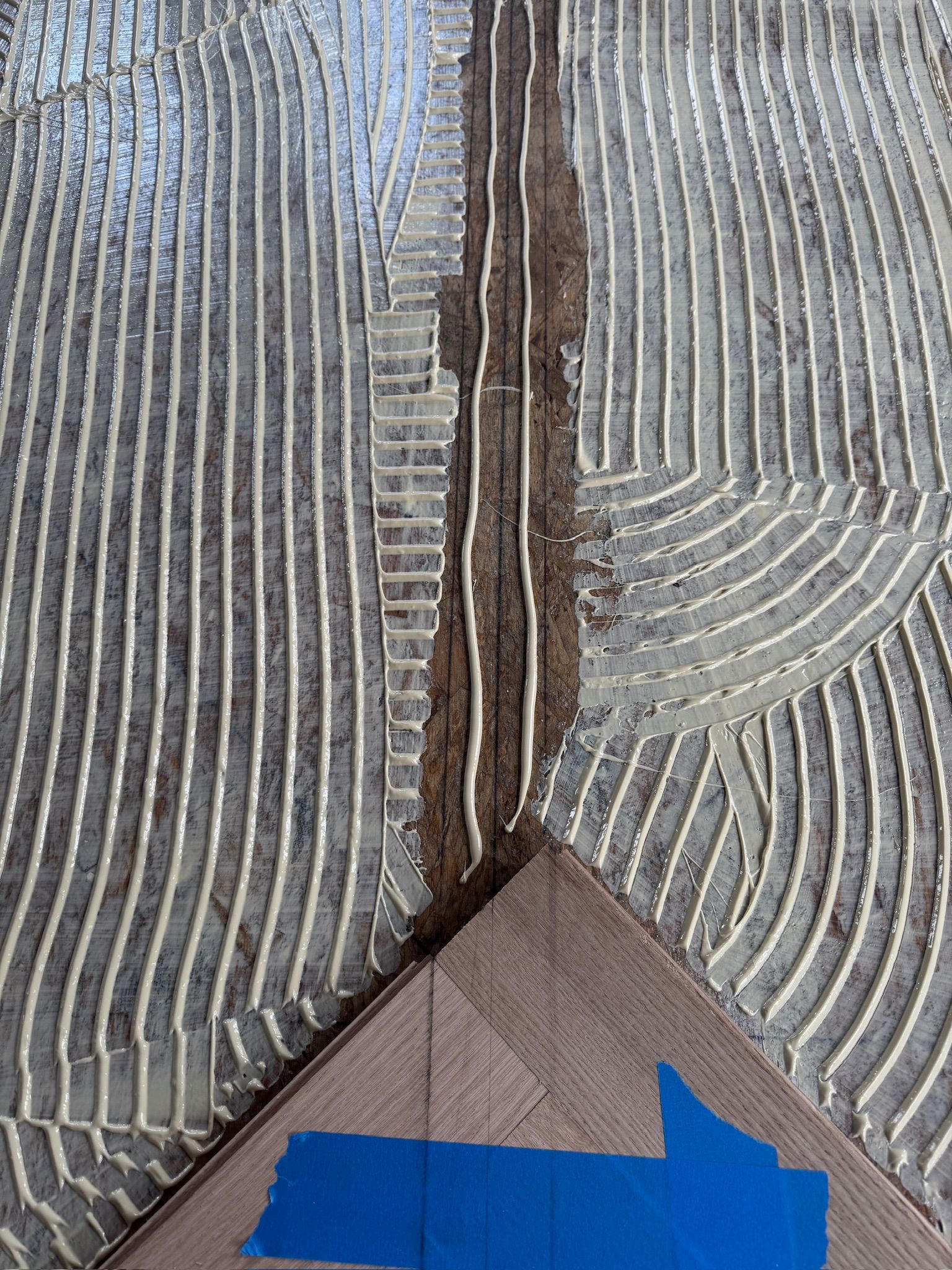 A close up of a piece of wood with glue on it.