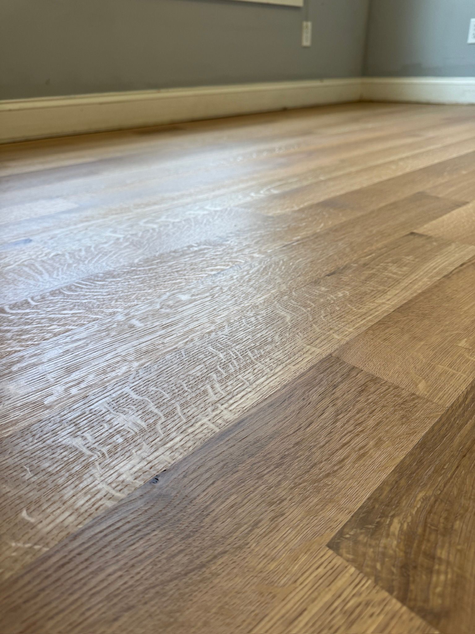 A close up of a wooden floor in a room.
