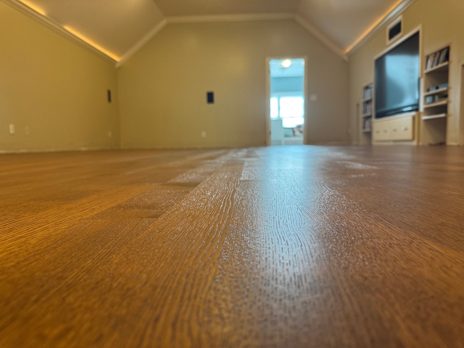 A living room with hardwood floors and a flat screen tv.