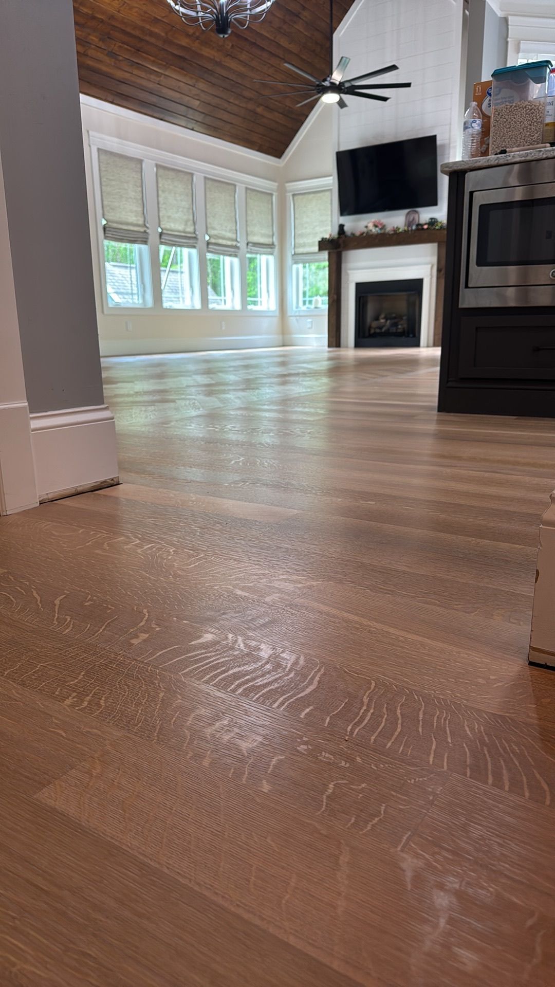 A living room with hardwood floors and a fireplace.
