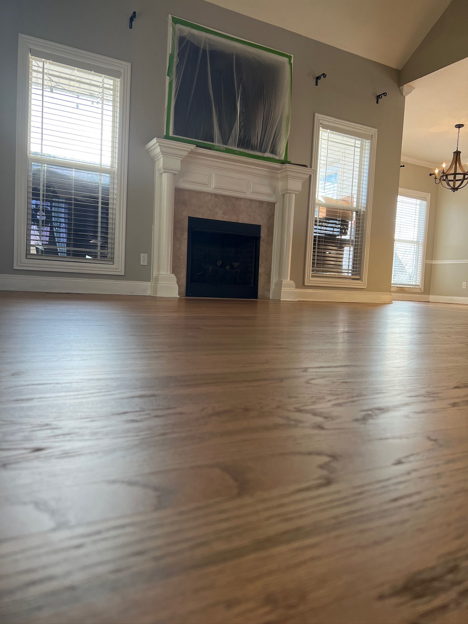 A living room with hardwood floors and a fireplace.