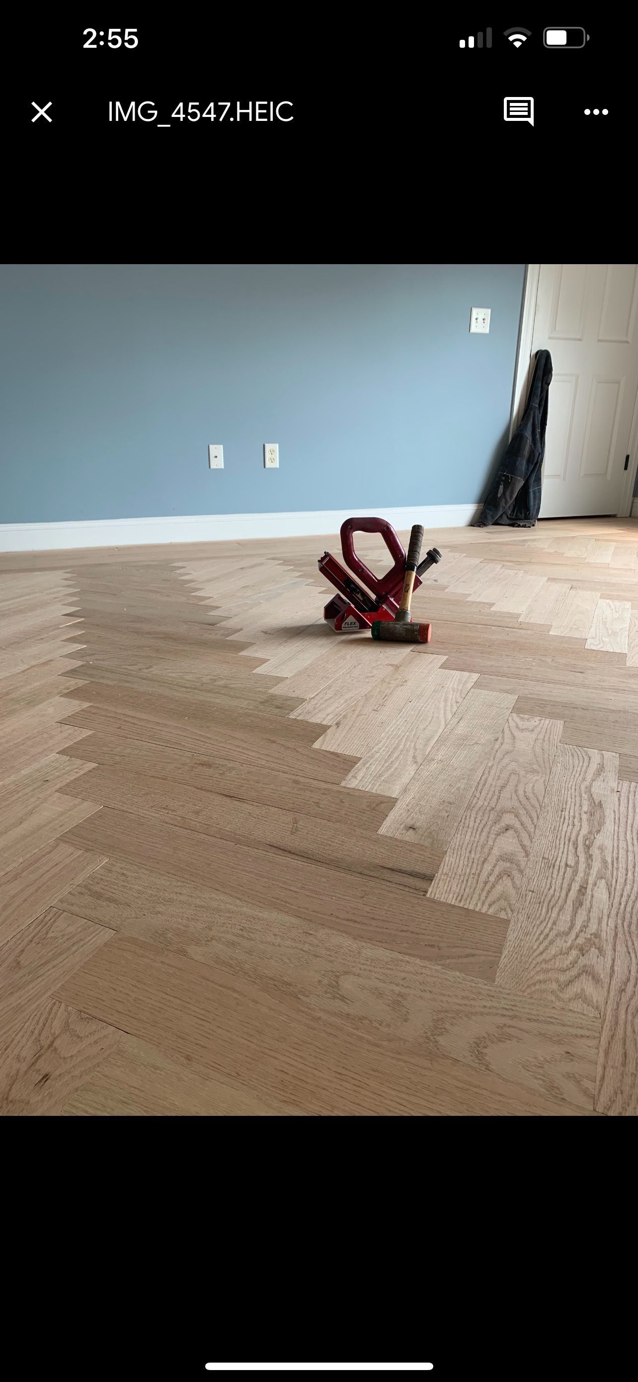 A picture of a wooden floor being installed on a cell phone.
