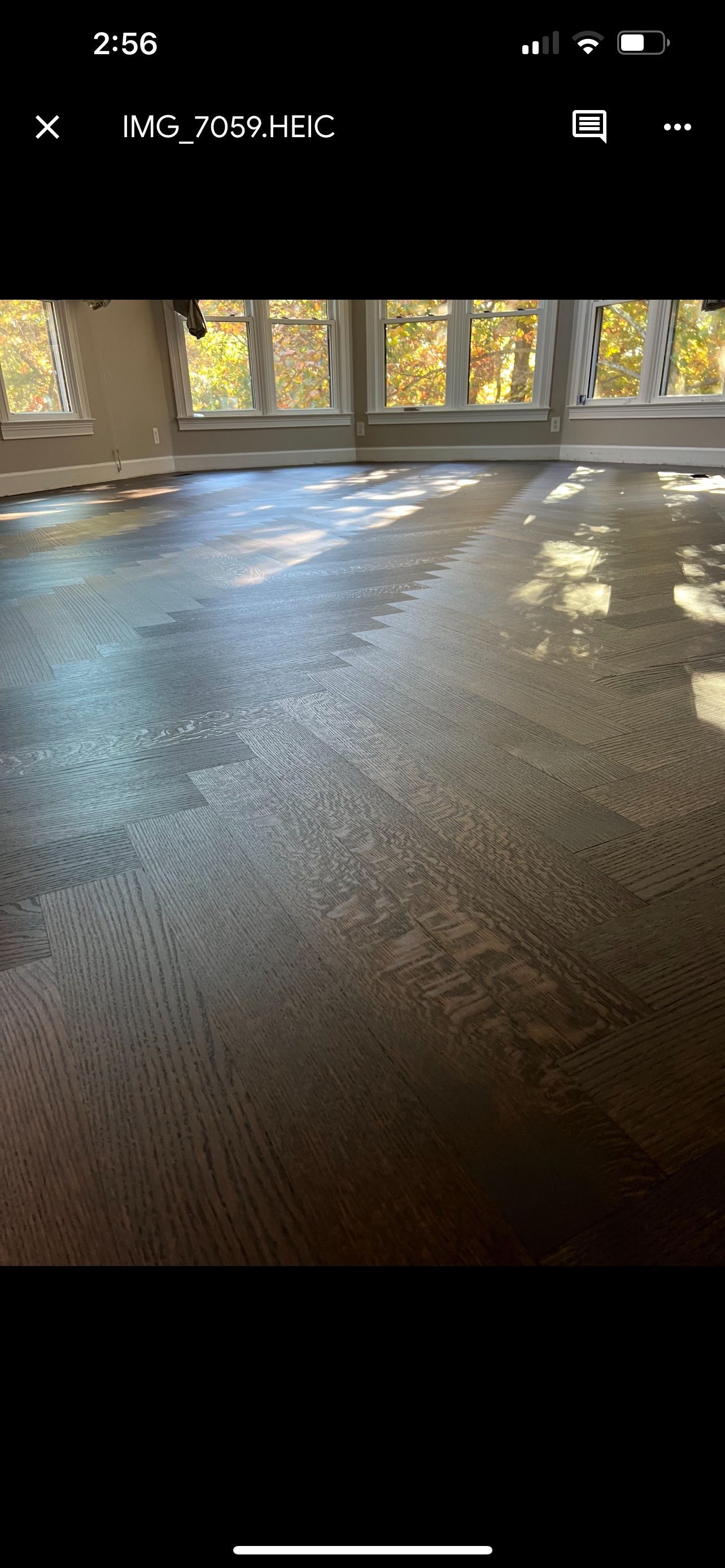 A room with a concrete floor and a lot of windows.