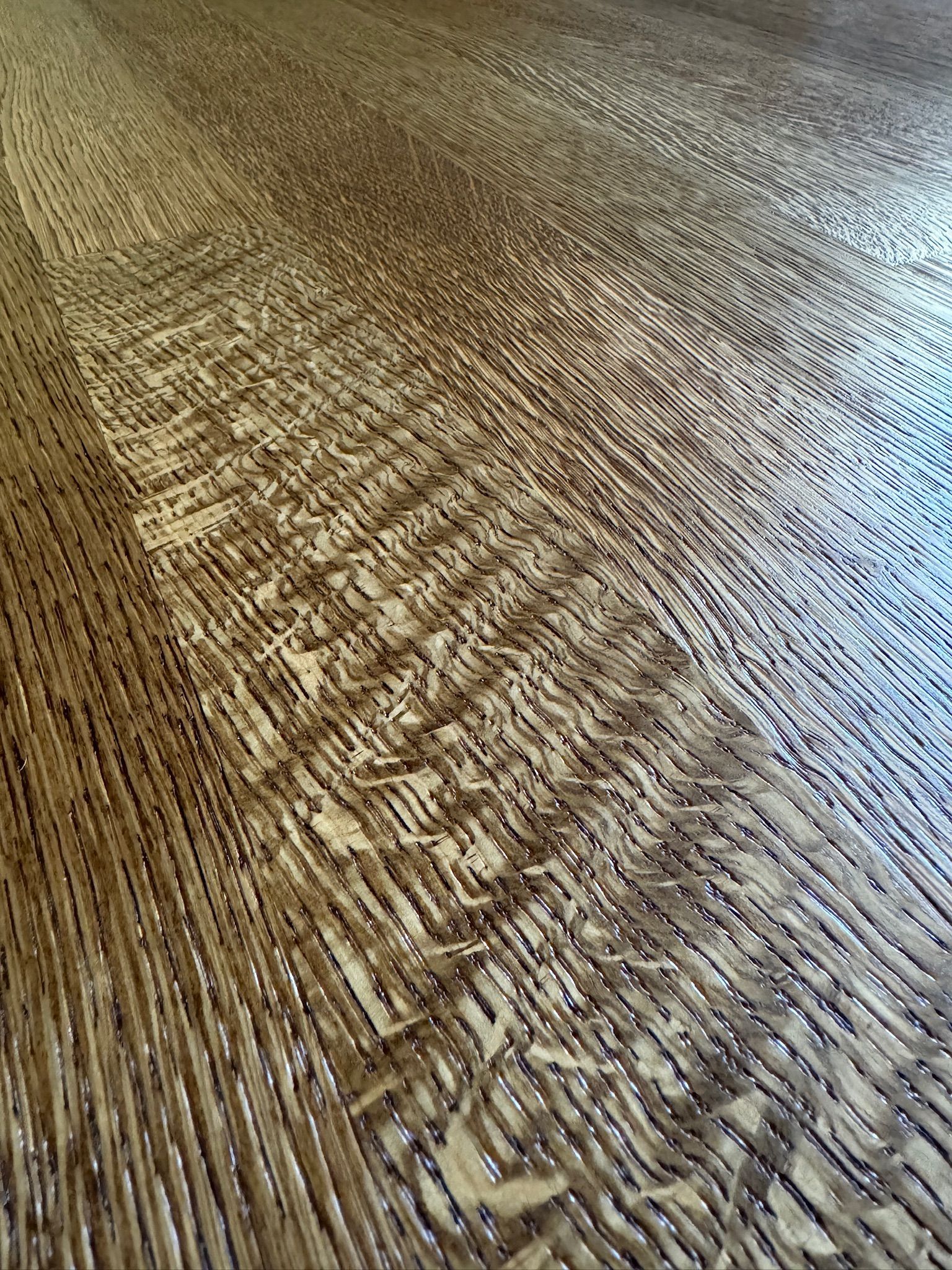A close up of a wooden floor with a pattern on it.