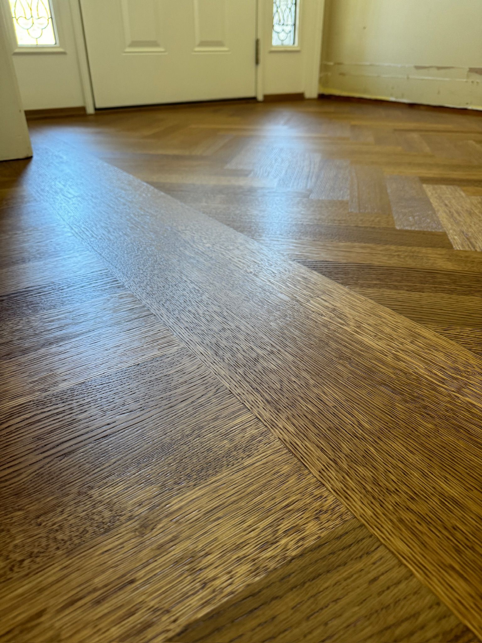 A room with a wooden floor and a white door.