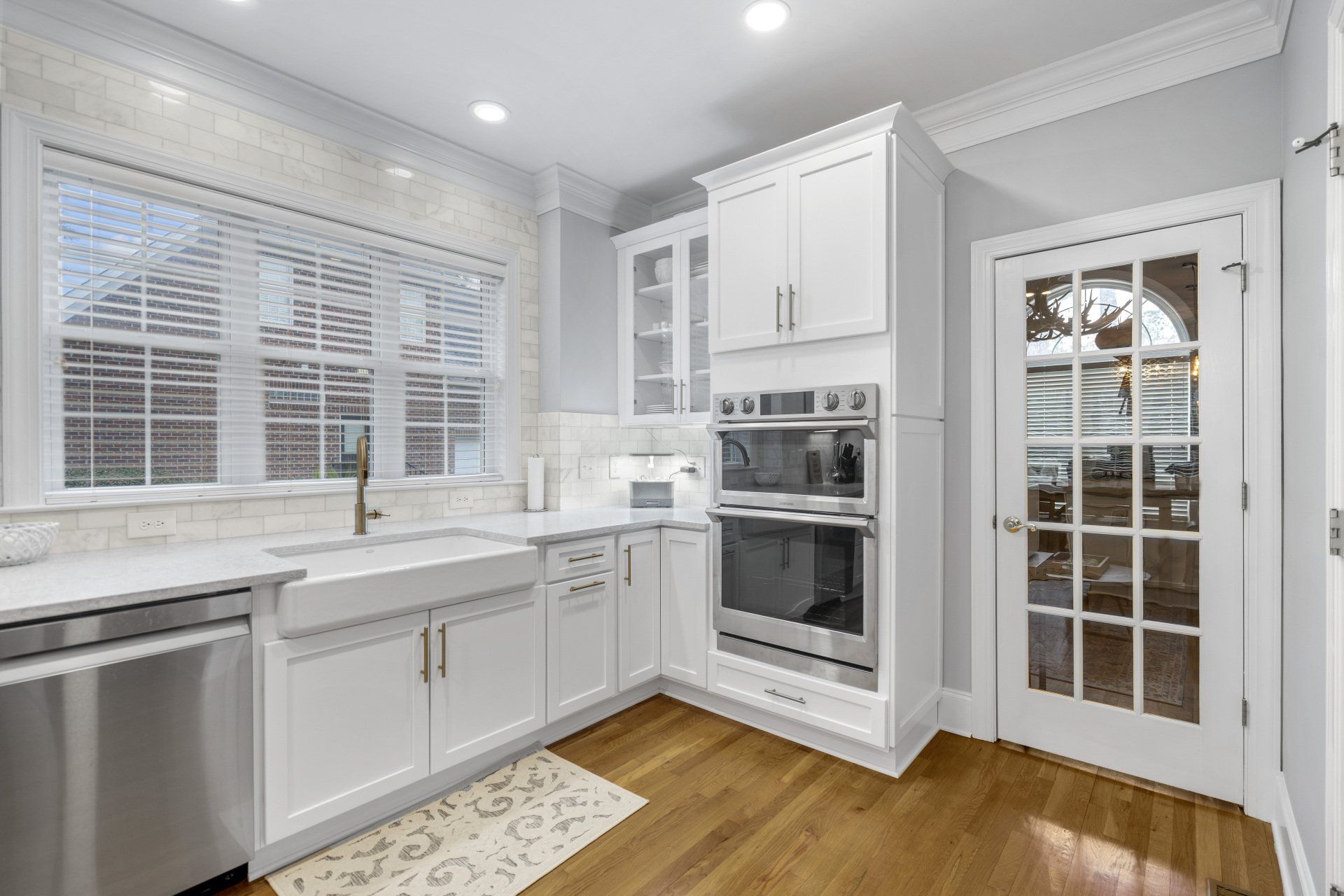 Built-in wall mount ovens and a procelain coated cast iron apron front farm sink.