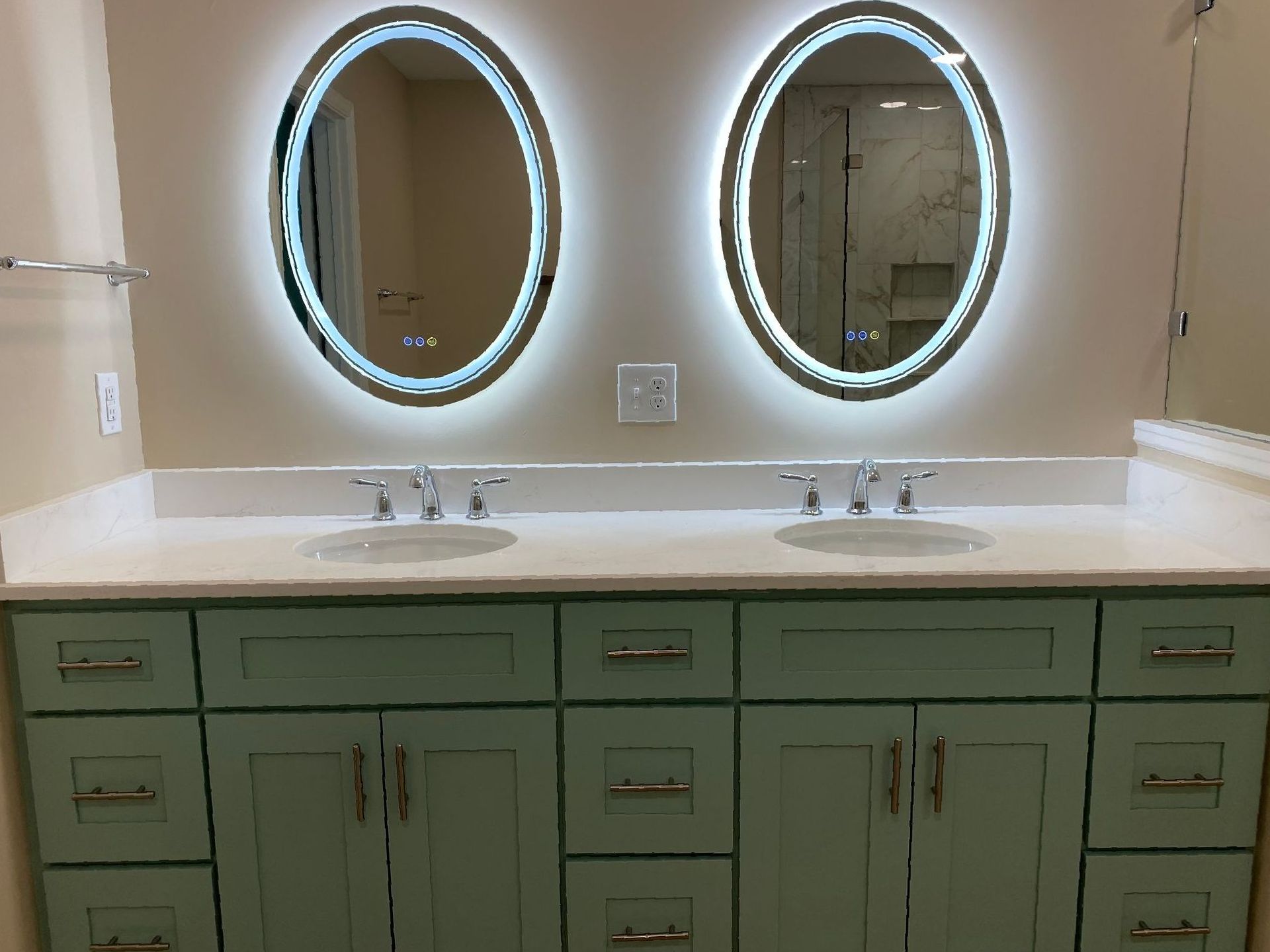 LED Lighted vanity mirrors for modern, functional lighting above a sea foam green double vanity.