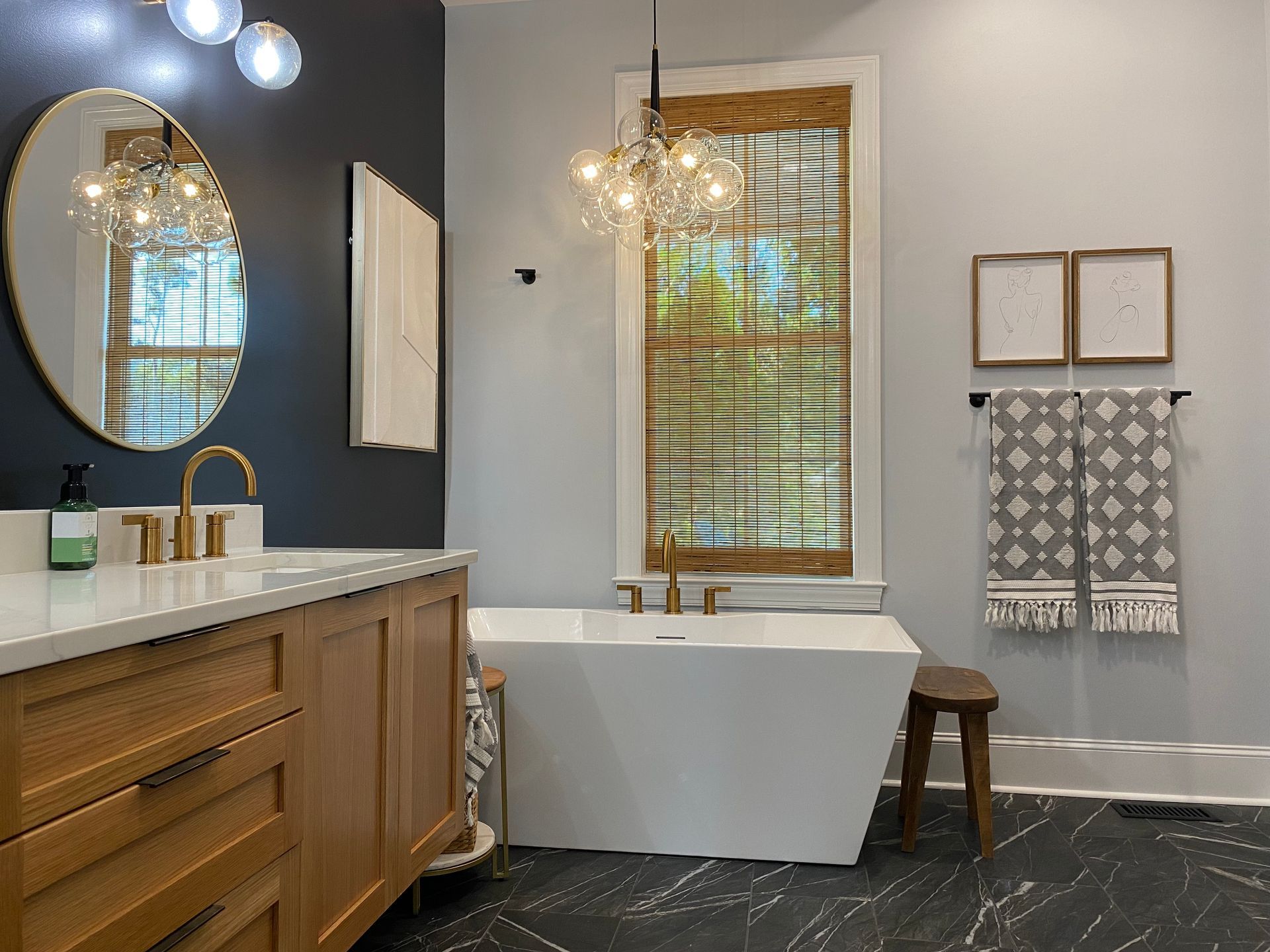 Moody bathroom remodel features black and white contrast walls.