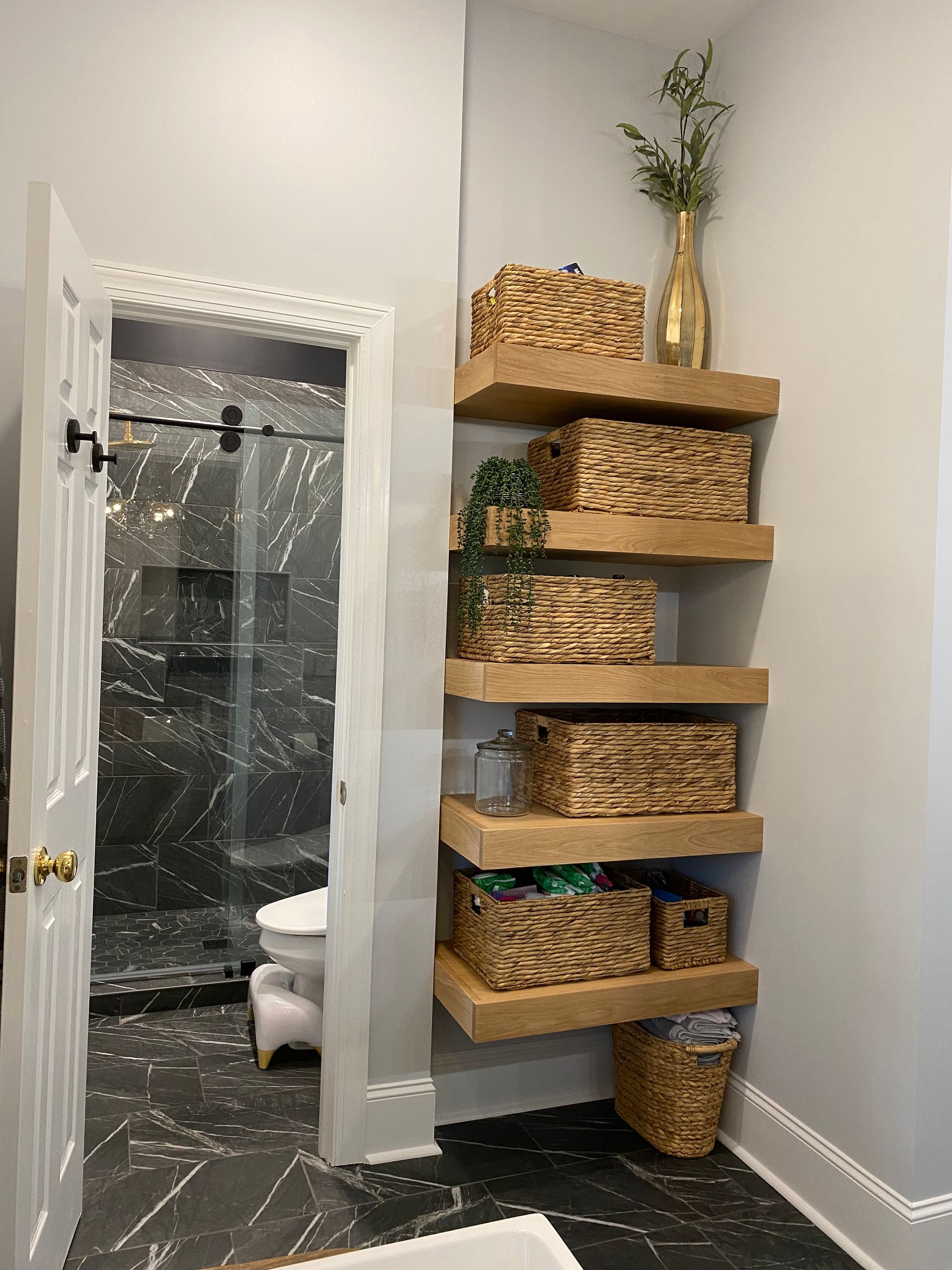 White oak floating shelves in bathroom for storage.