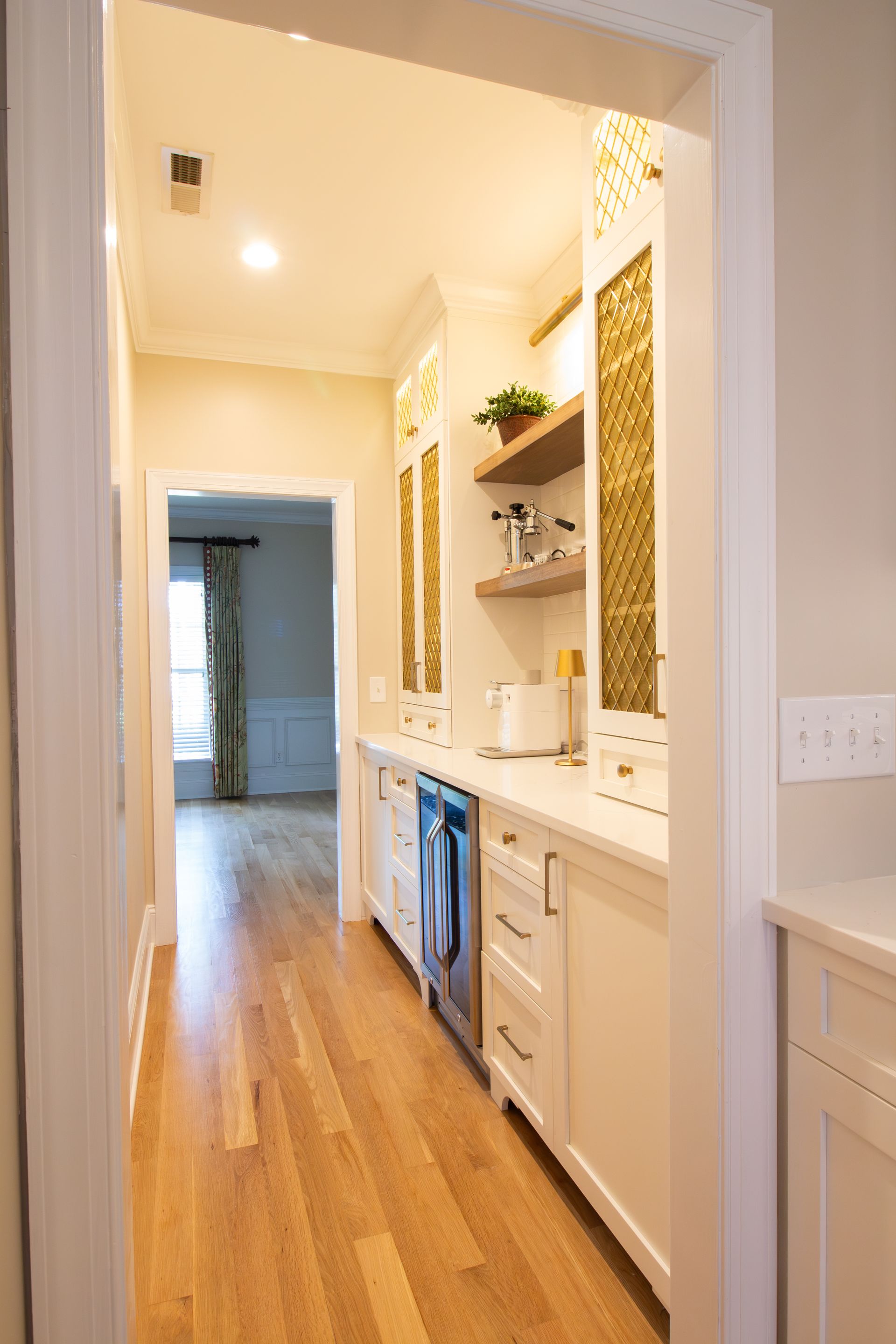 Butlers pantry area with coffee bar and floating shelves.
