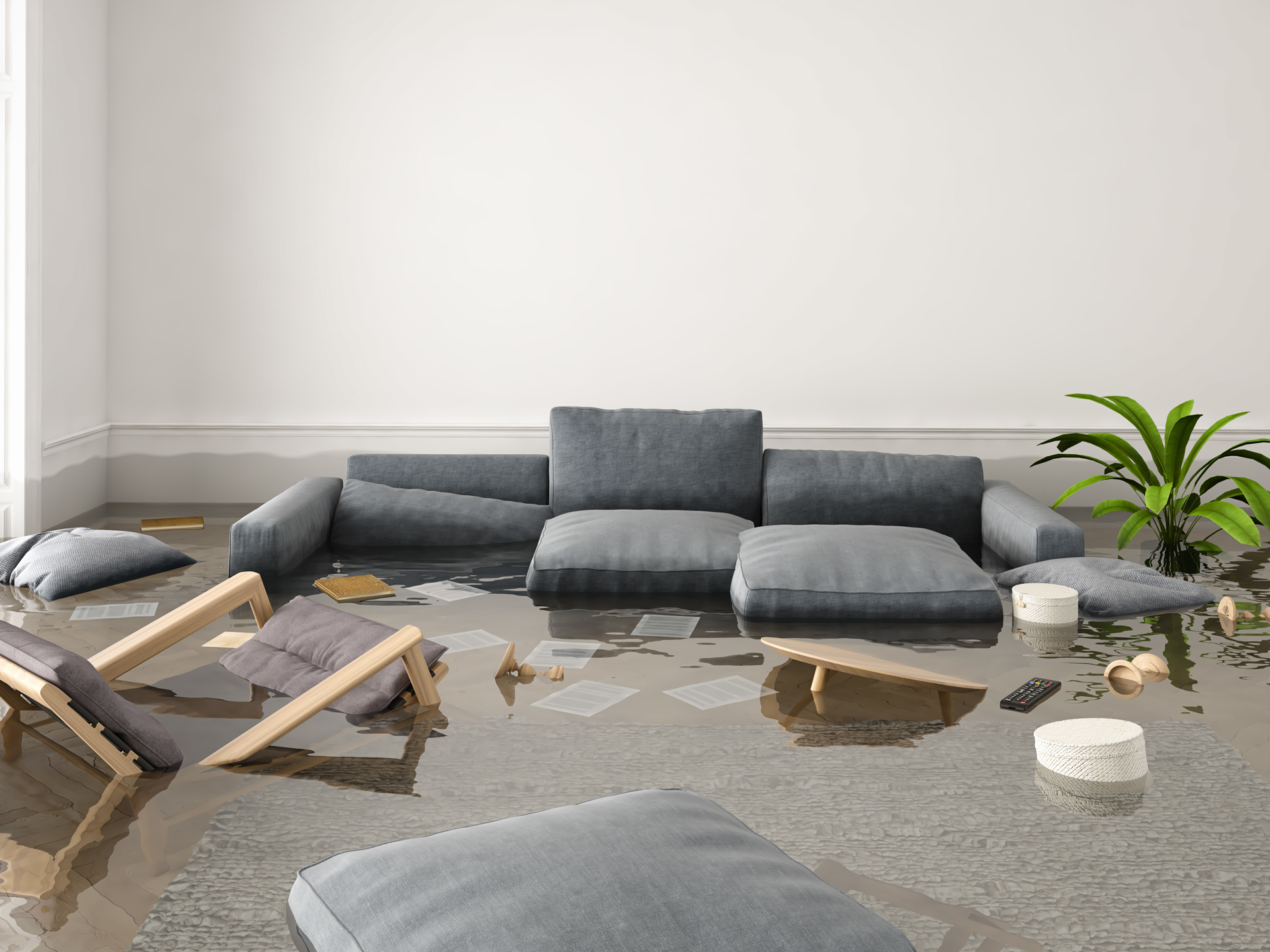 a living room flooded with water and a couch and chairs .