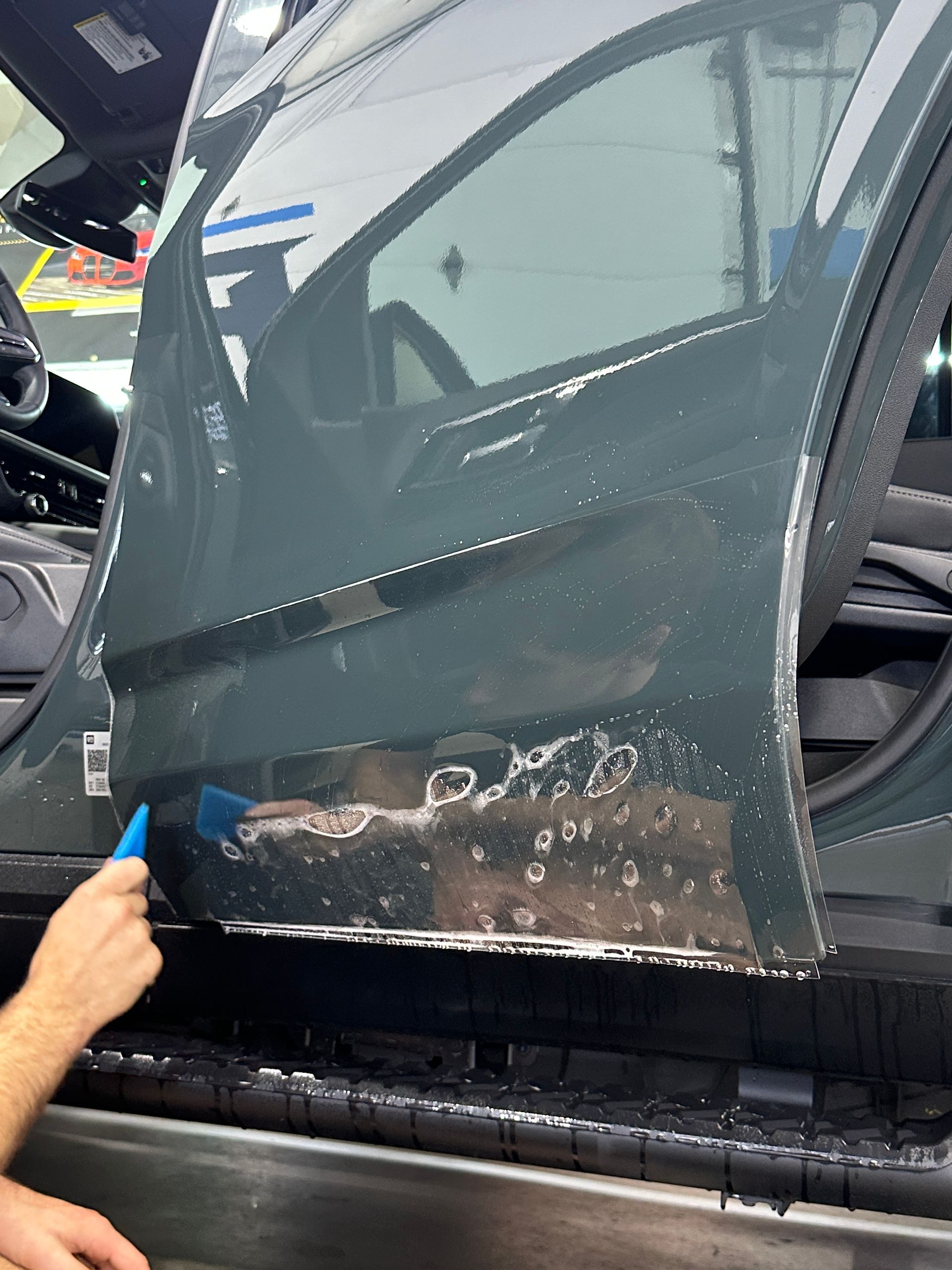 A black jeep grand cherokee is parked in front of a building.