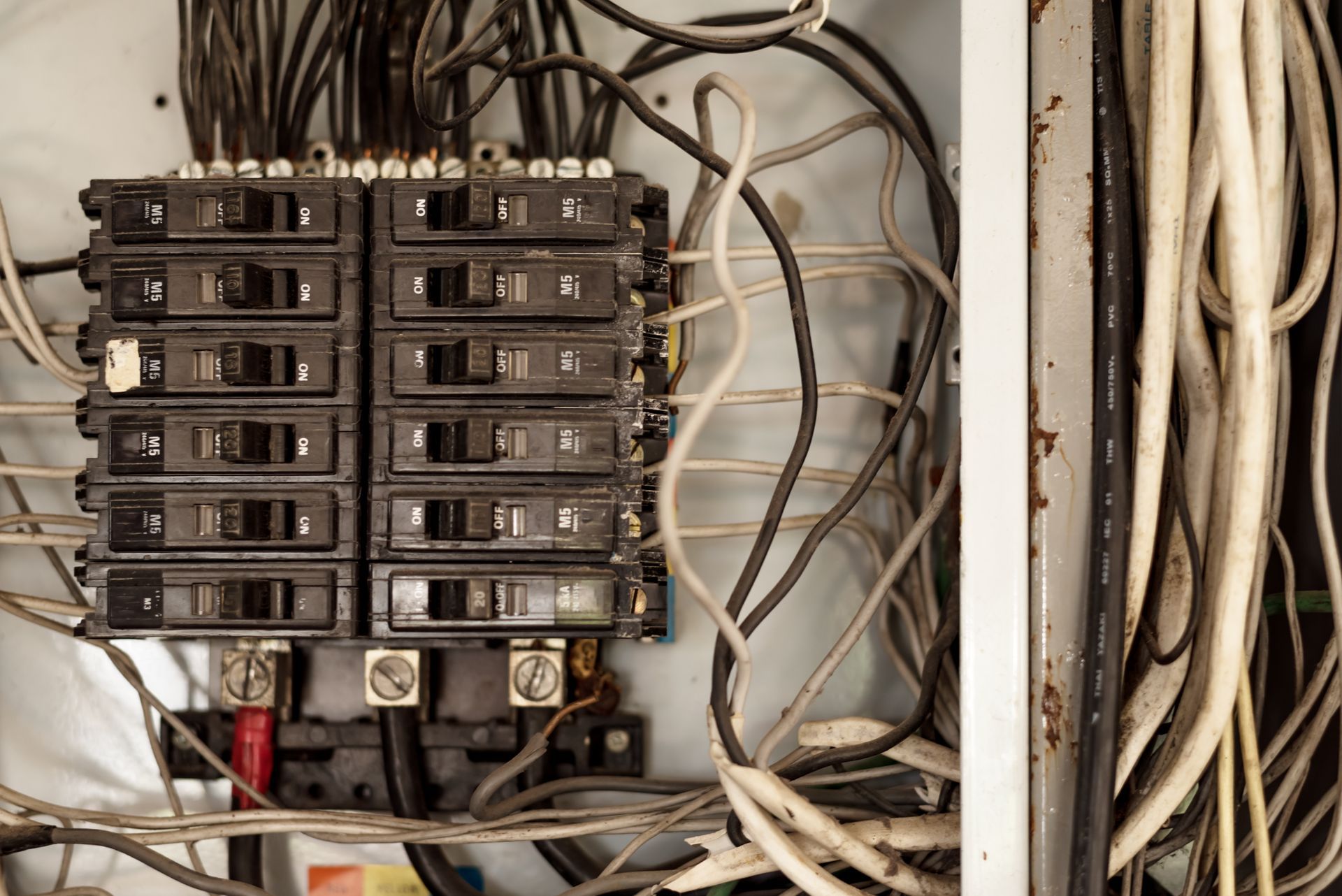 A close up of an electrical box with a lot of wires coming out of it.