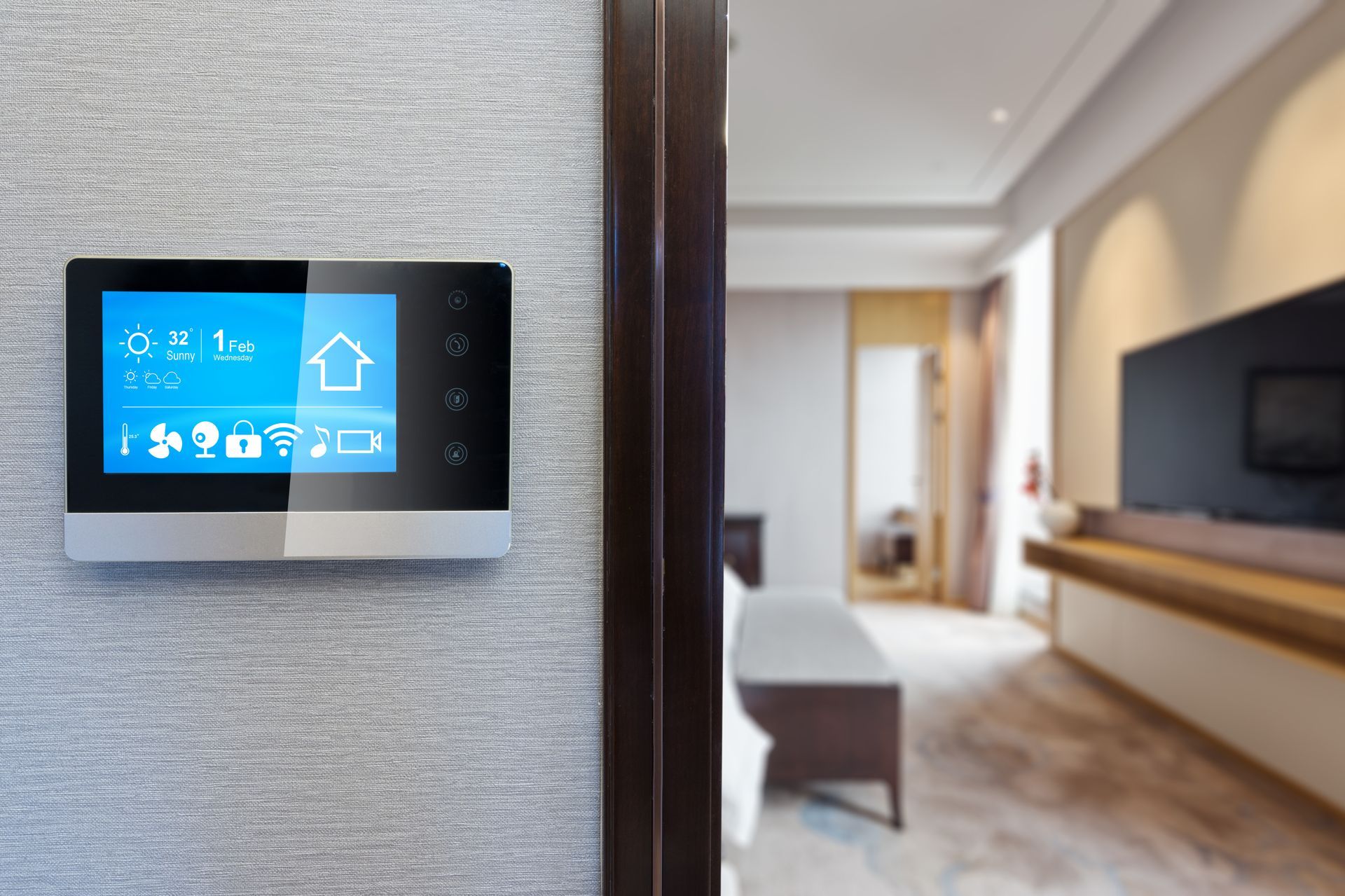 A smart thermostat is hanging on a wall in a living room.