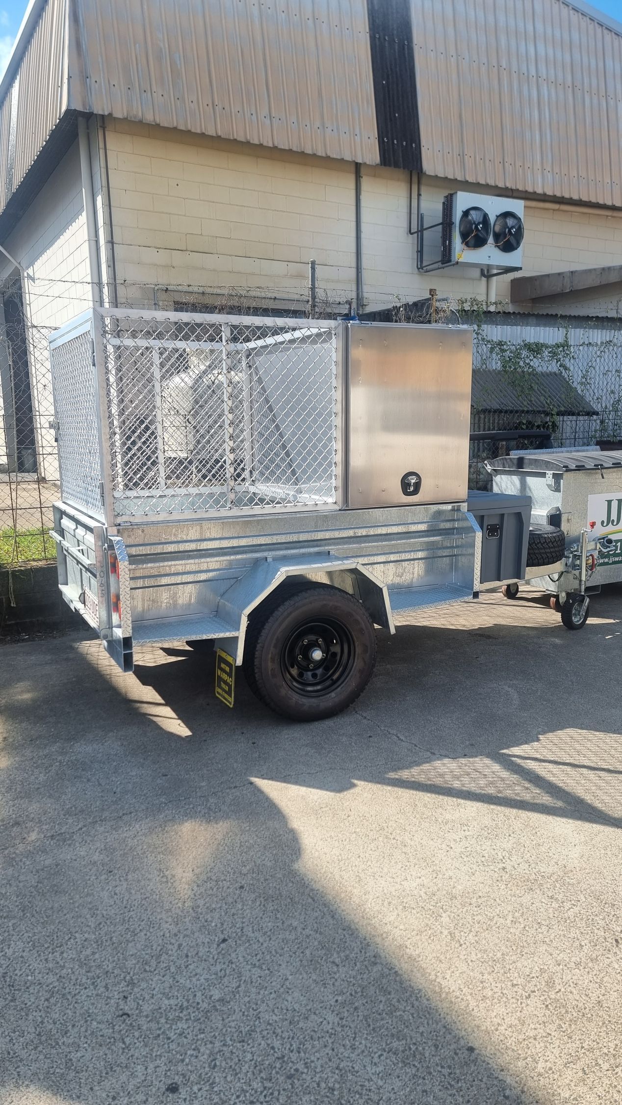A Metal Cage Is Sitting on A Table in Front of A Building that Says Miningwell Insulation — Mingweld Fabrication in Bungalow, QLD