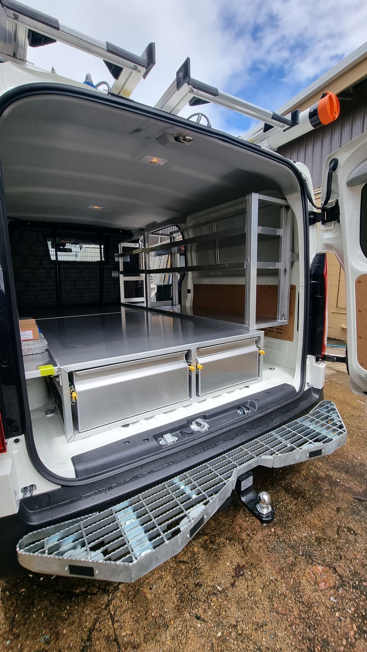 The back of a van with the door open and shelves in it — Mingweld Fabrication in Bungalow, QLD