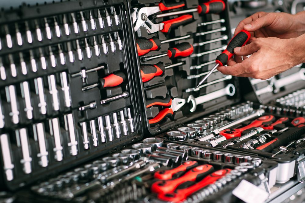 Tool Kit Open with Various Tools, a Person Holding a Screwdriver — Mingweld Fabrication in Bungalow, QLD