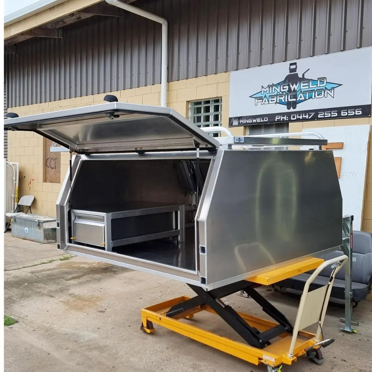 A Stainless Steel Canopy Is Parked in Front of A Building — Mingweld Fabrication in Bungalow, QLD