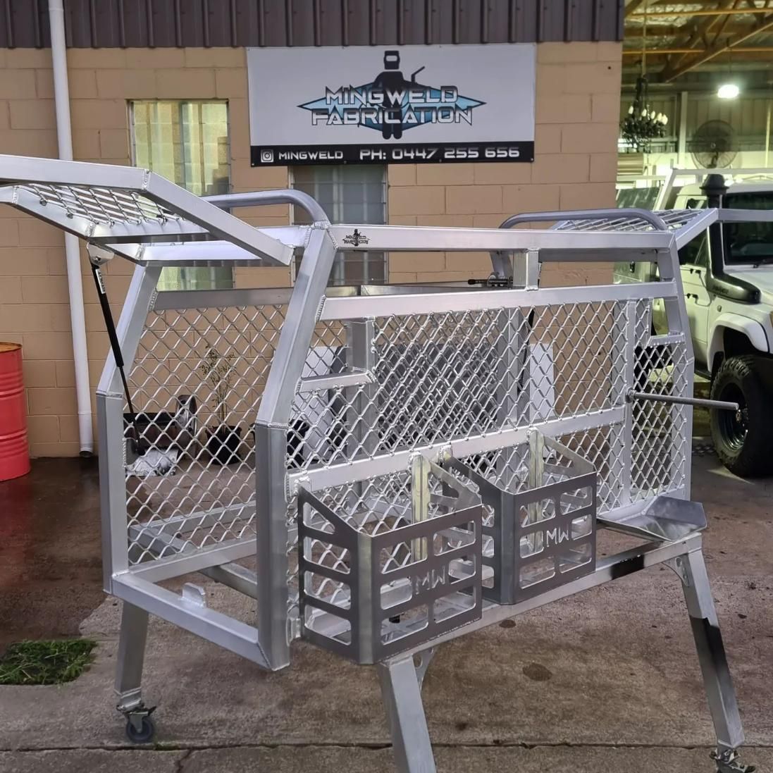 A Metal Cage Is Sitting in Front of A Building with A Sign that Says 'Aluminum Simulator' on It — Mingweld Fabrication in Bungalow, QLD