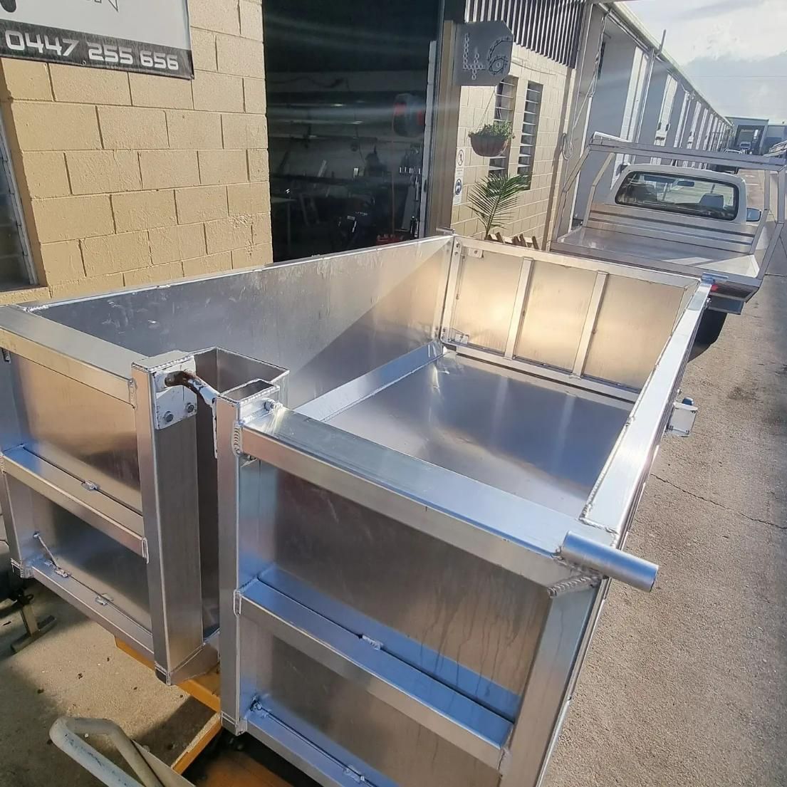 A Large Aluminum Container Is Sitting on The Side of The Road in Front of A Building — Mingweld Fabrication in Bungalow, QLD