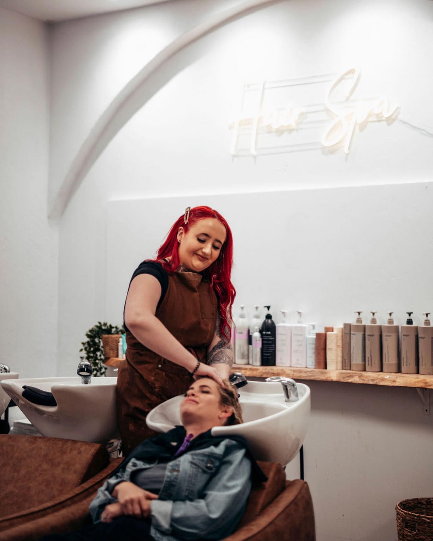A Woman is Washing Another Woman 's Hair in a Salon — Tree House Salon In Nerang, QLD