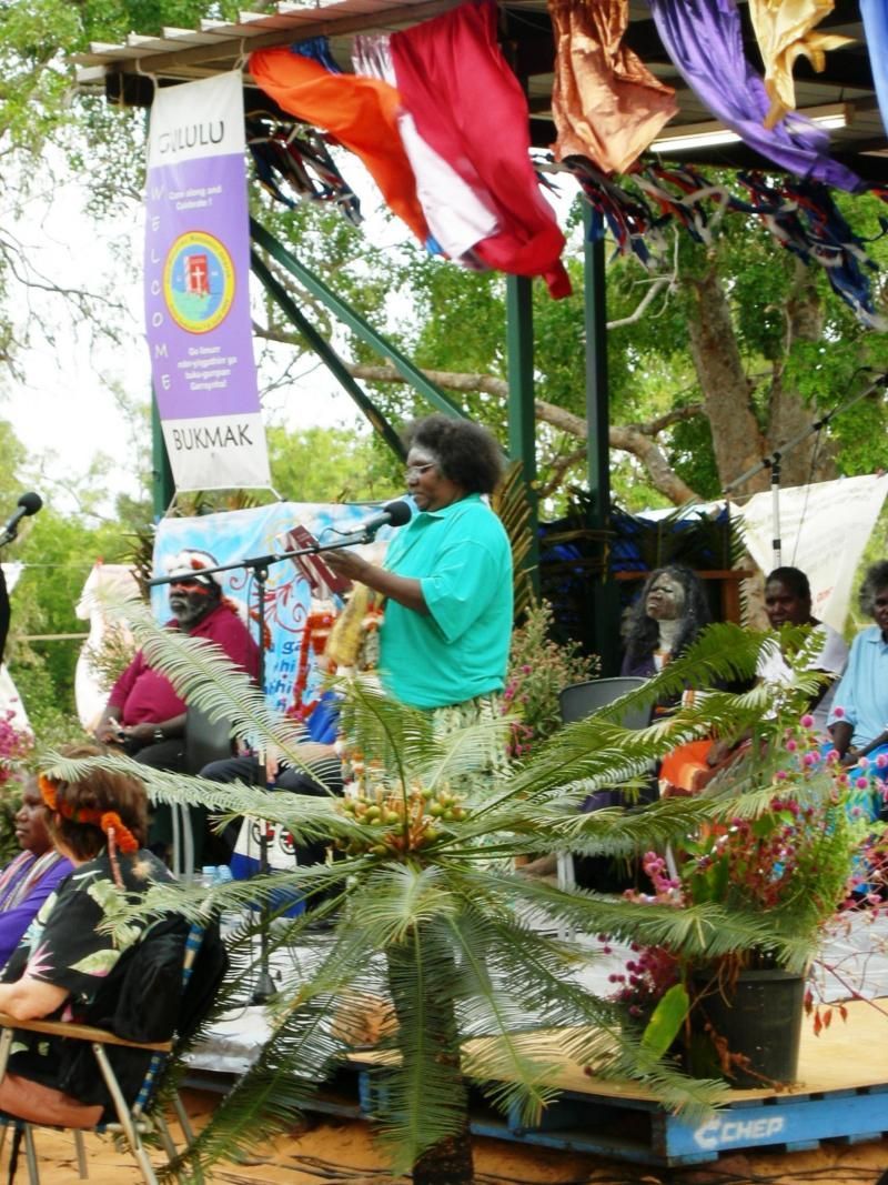 A group of people are gathered around a stage with a banner that says ' freedom ' on it