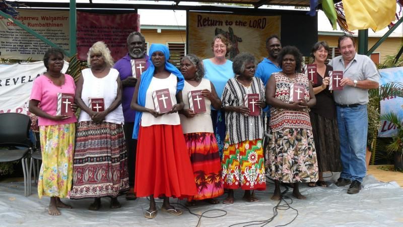 A group of people standing in front of a sign that says level