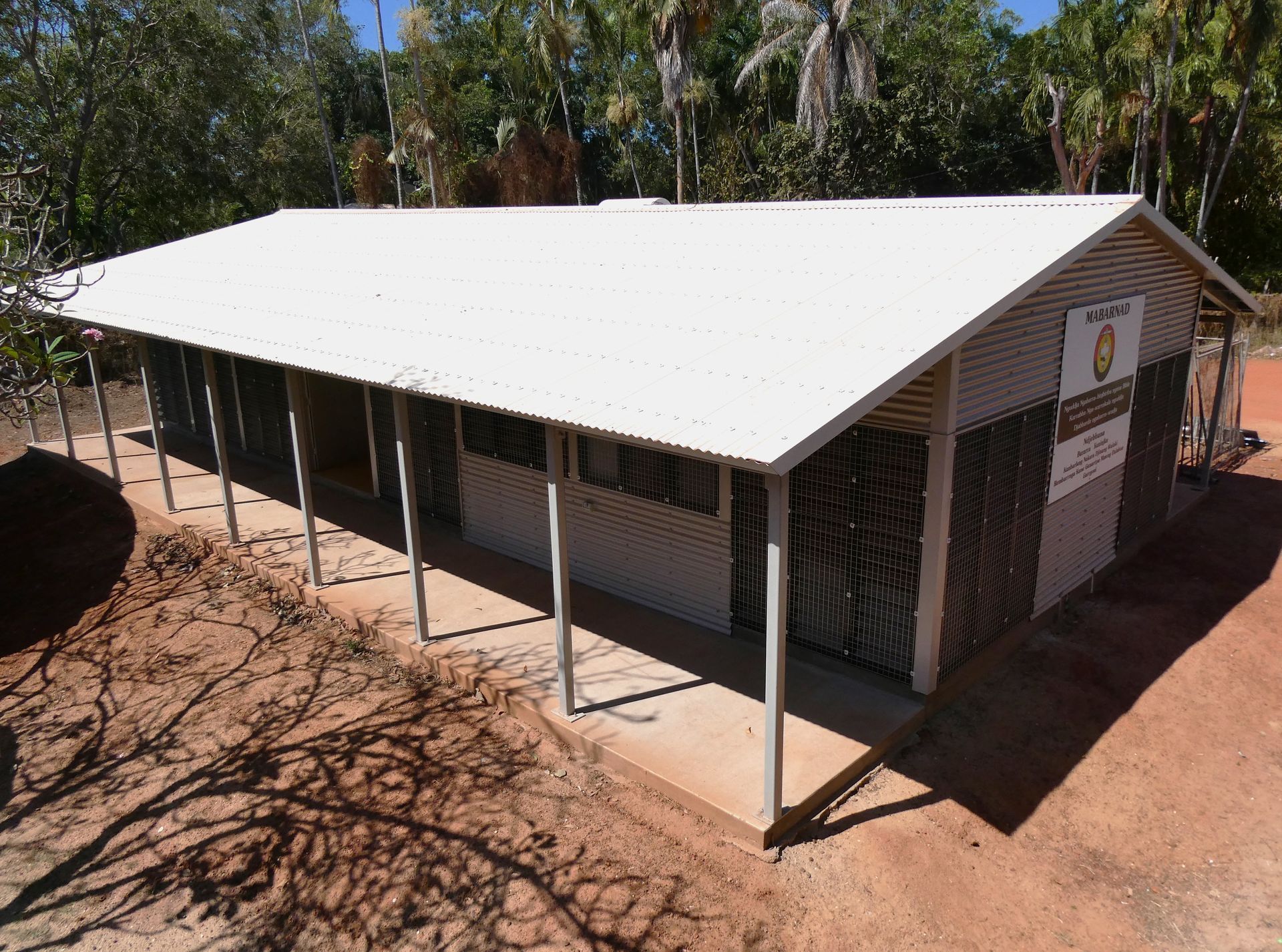 An aerial view of a building with a white roof