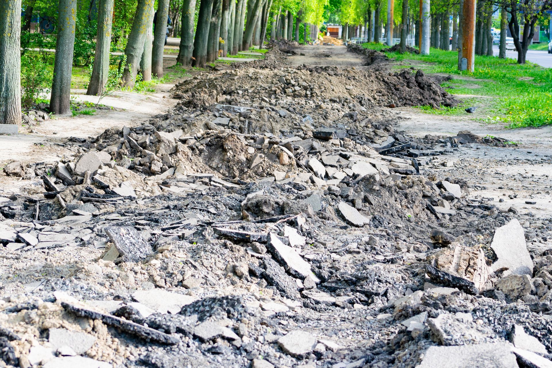 A muddy road with a lot of dirt and rocks on it.