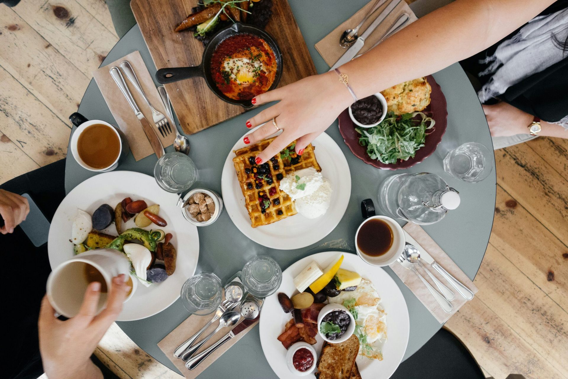 A group of people are sitting at a table eating food.