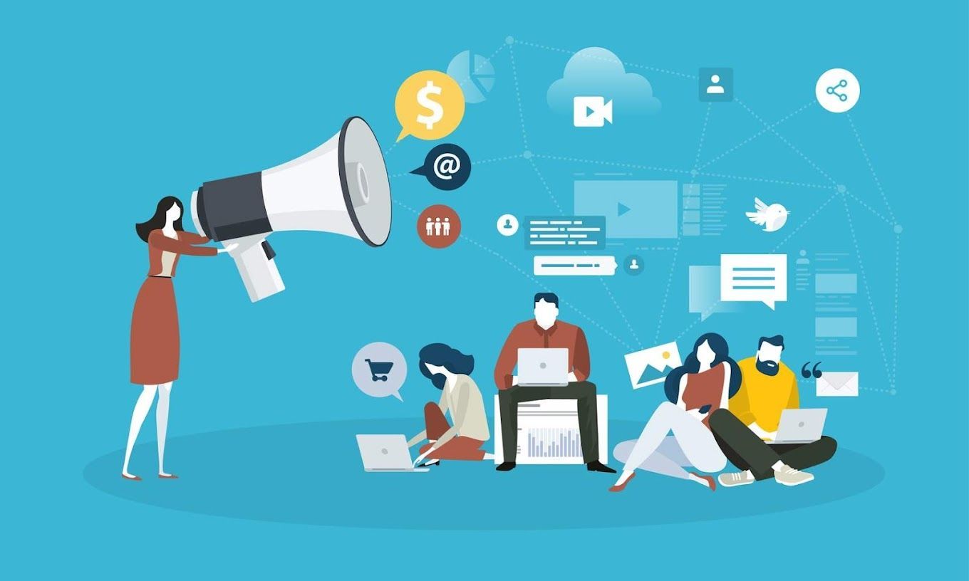 A woman is holding a megaphone in front of a group of people sitting on the floor with laptops.