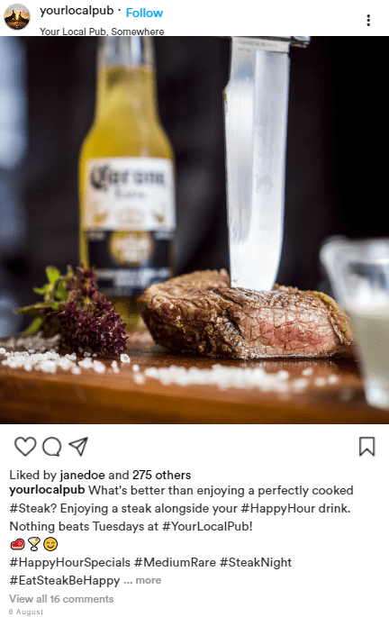 A steak is being cut on a cutting board next to a bottle of corona beer.