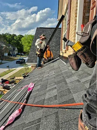 Roof Replacement Labor Costs in Georgia Roof installers working on a residential roof in Georgia, representing labor factors that influence roof replacement pricing.