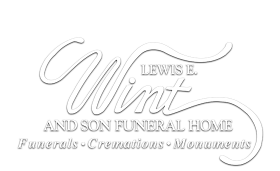 Lewis E. Vint and Son Funeral Home logo with elegant script and floral flourish on a white background