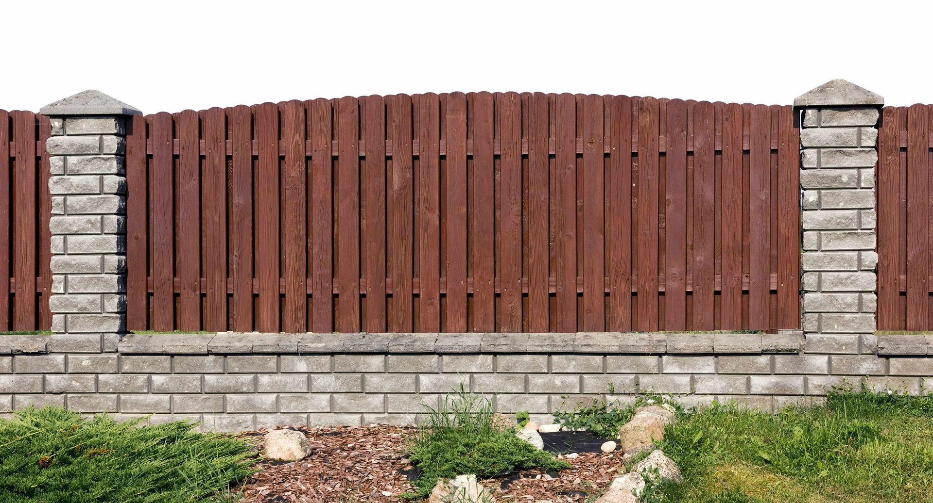 Newly constructed wood fence on bricks