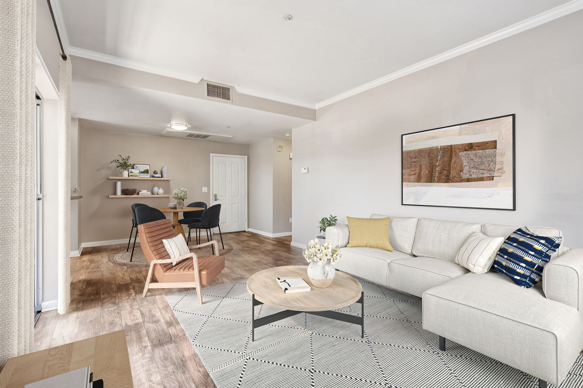 Living room with light gray walls, white couch, and wood floors.